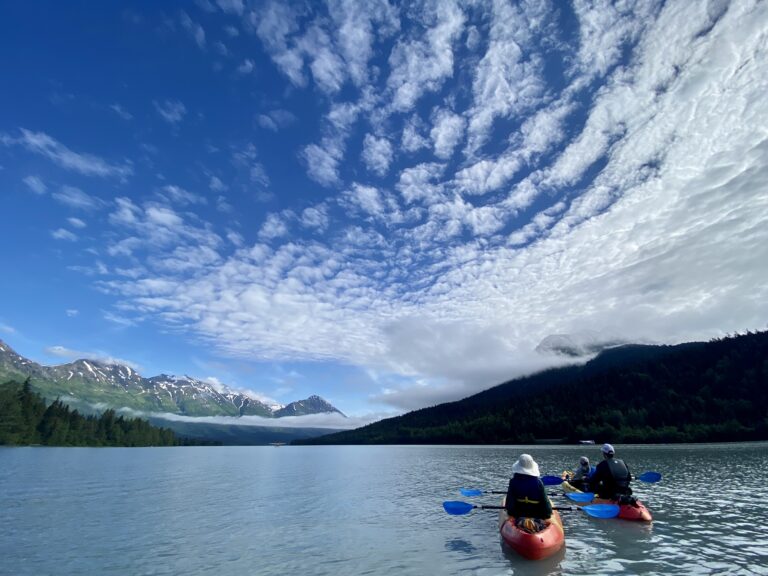 2 tandem kayaks on serene Upper Trail Lake in Moose Pass, Alaska