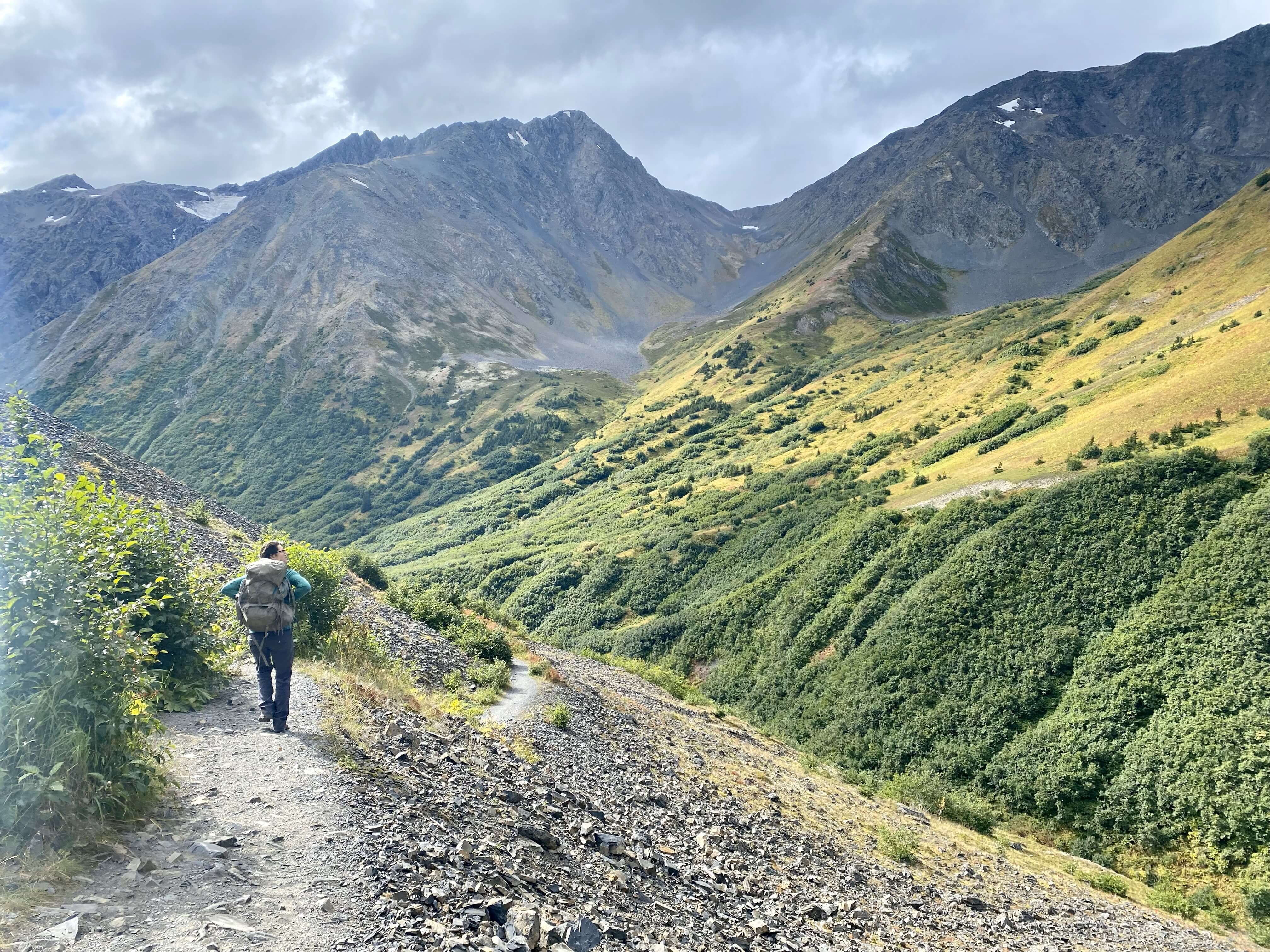 Hiker in a group trekking through the Alaskan backcountry on a scenic trail